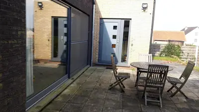 a patio with a table and chairs on it at Villa in Diest nabij het groen in Diest
