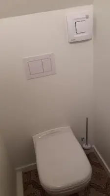 a white toilet in a bathroom with a white wall at Villa in Diest nabij het groen in Diest