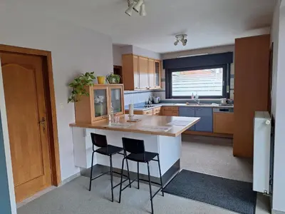 a kitchen with a island with two stools in it at Villa in Diest nabij het groen in Diest