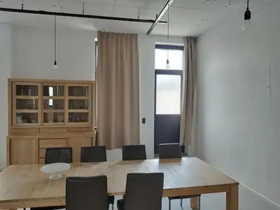 a dining room with a wooden table and chairs at Boom Loft 9 in Boom
