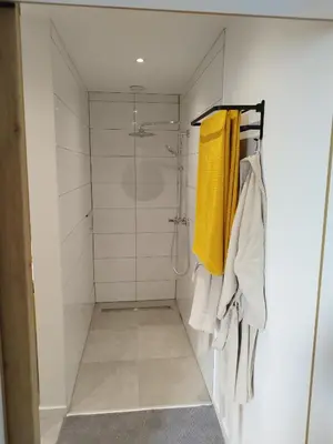 a bathroom with a shower with yellow towels at Boom Loft 9 in Boom