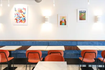 a dining room with tables and chairs and paintings on the wall at BX Downtown - Brussels in Brussels