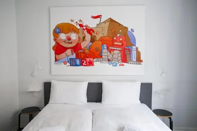 a bedroom with a bed with a painting on the wall at BX Downtown - Brussels in Brussels