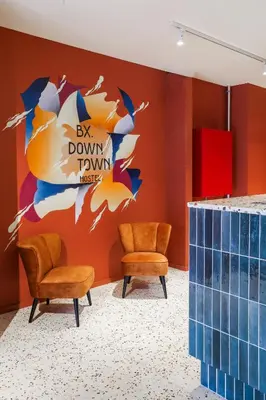 a waiting room with two chairs and a wall with a sign at BX Downtown - Brussels in Brussels