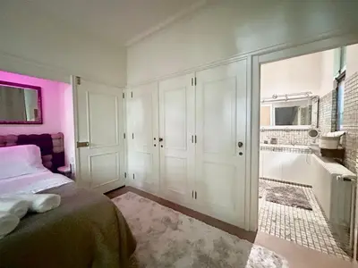 a bedroom with a bed and a bathroom at Luxury suite with a private terrace in Diest