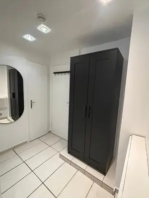 a bathroom with a black cabinet and a mirror at Comfortable Apartment in Brussels, 35 m², 3 Persons in Brussels