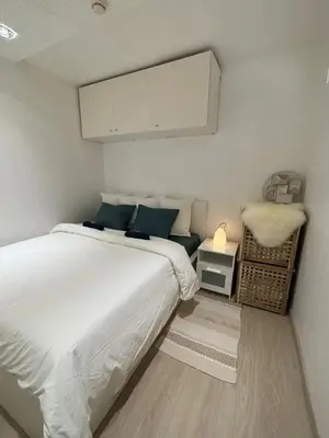 a bedroom with a white bed and a white cabinet at Comfortable Apartment in Brussels, 35 m², 3 Persons in Brussels