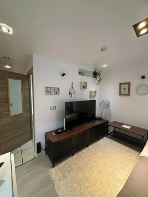 a living room with a flat screen tv on a wall at Comfortable Apartment in Brussels, 35 m², 3 Persons in Brussels