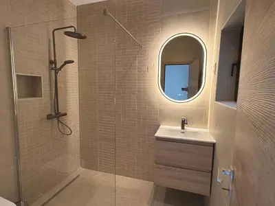 a bathroom with a shower and a sink and a mirror at Le Goujons - New apartment near Midi Station in Brussels
