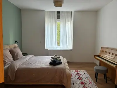 a bedroom with a bed with a stuffed animal on it at Le Goujons - New apartment near Midi Station in Brussels