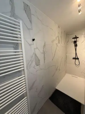 a bathroom with a white marble wall at TML 500m - Luxury Penthouse with 2 Balconies in Boom