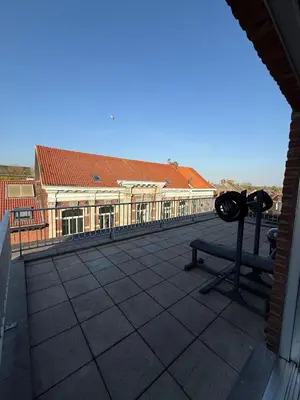 a balcony with a bench and a building at TML 500m - Luxury Penthouse with 2 Balconies in Boom