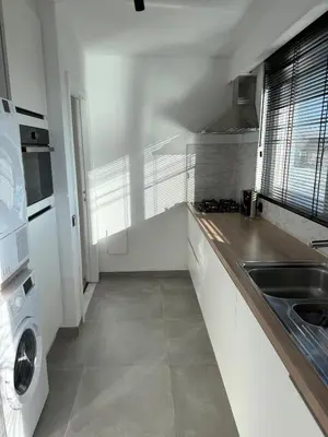 a white kitchen with a sink and a stove at TML 500m - Luxury Penthouse with 2 Balconies in Boom