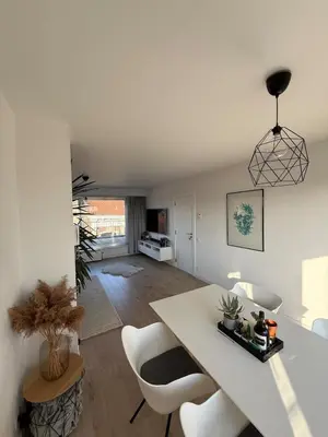 a living room with a white table and chairs at TML 500m - Luxury Penthouse with 2 Balconies in Boom