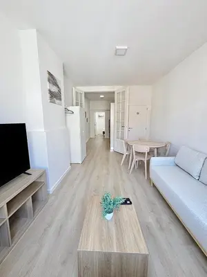 a living room with a couch and a table at Élégant appartement une chambre in Brussels