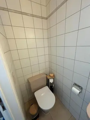 a small bathroom with a white toilet in it at The Heart of Petit Sablon in Brussels