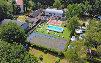 an aerial view of a house with a tennis court at Camping Het Veen in Brecht