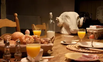 a table with food and a bottle of milk and orange juice at Gastenlogies Blauwe Schaap in Ranst
