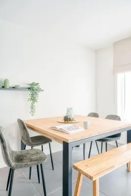 a dining room with a wooden table and chairs at Charming & Central Stay with Terrace in Ghent