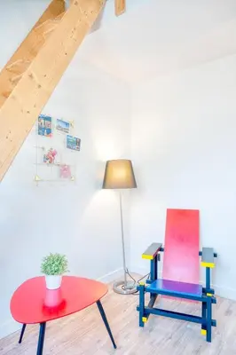 a room with two chairs and a table and a lamp at Charming & Central Stay with Terrace in Ghent
