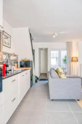 a living room with a couch and a kitchen at Charming & Central Stay with Terrace in Ghent