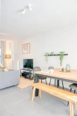 a living room with a table and a couch at Charming & Central Stay with Terrace in Ghent