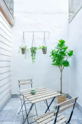 a table and two benches on a patio with plants at Charming & Central Stay with Terrace in Ghent
