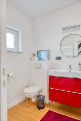 a bathroom with a red sink and a toilet at Charming & Central Stay with Terrace in Ghent