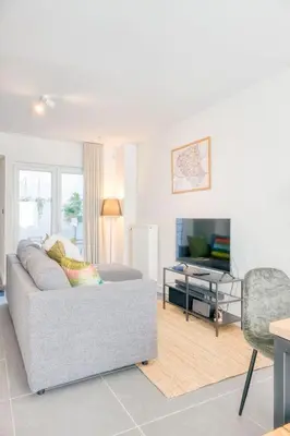 a living room with a couch and a television at Charming & Central Stay with Terrace in Ghent