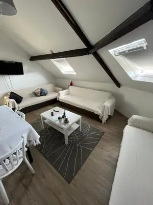 a living room with two beds and a table at Cozy Nest by Gare du Midi in Brussels