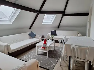 a living room with white couches and a table at Cozy Nest by Gare du Midi in Brussels