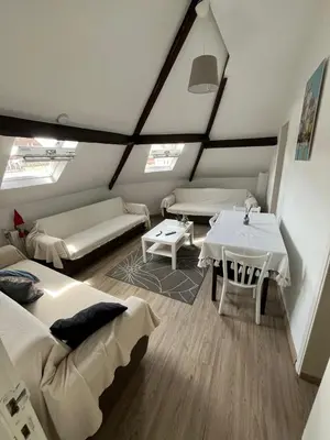 a living room with two beds and a table at Cozy Nest by Gare du Midi in Brussels