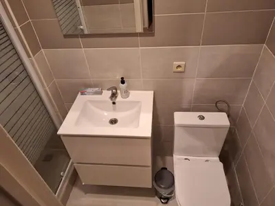 a small bathroom with a sink and a toilet at Cozy Nest by Gare du Midi in Brussels