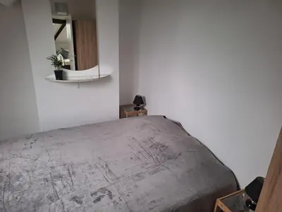 a bedroom with a bed and a mirror on the wall at Cozy Nest by Gare du Midi in Brussels
