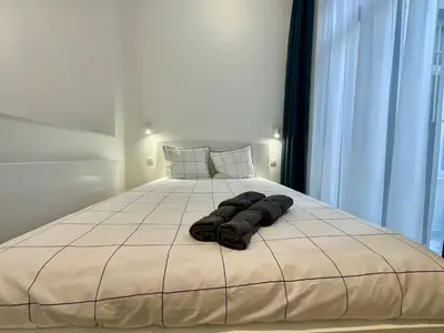 a bed with two pairs of towels on it at Chapeliers in Brussels