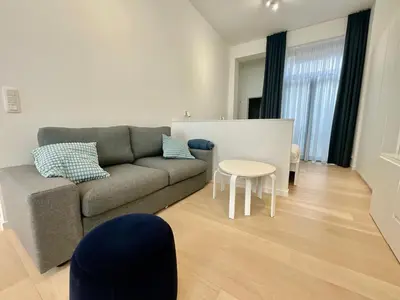 a living room with a couch and a table at Chapeliers in Brussels