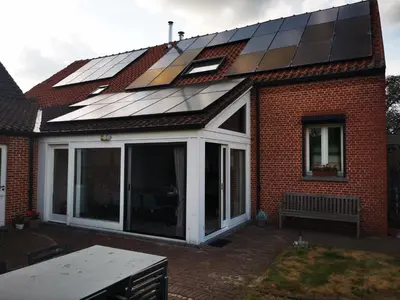 a house with a roof with solar panels on it at Cor-U in Dessel