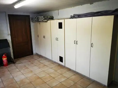 a row of white lockers in a room at Cor-U in Dessel