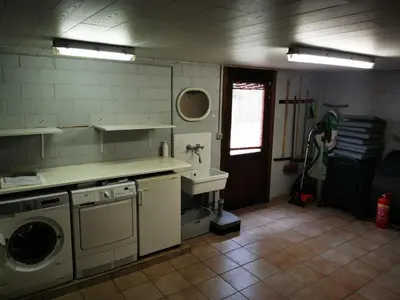 a kitchen with a washing machine and a sink at Cor-U in Dessel