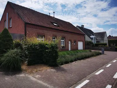 a red brick house with a driveway in front of it at Cor-U in Dessel