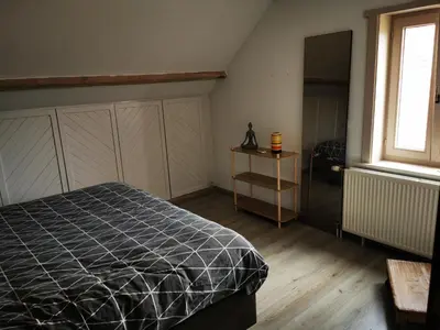 a bedroom with a bed and a window at Cor-U in Dessel