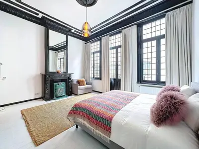 a bedroom with a bed and a fireplace at JAMES AT20 - luxury downtown Antwerp villa in Antwerp