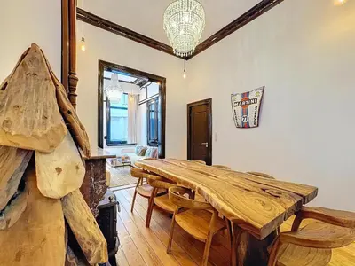 a dining room with a wooden table and chairs at JAMES AT20 - luxury downtown Antwerp villa in Antwerp