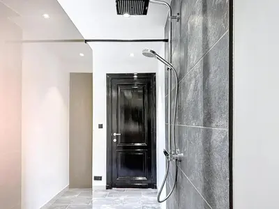 a shower in a bathroom with a black door at JAMES AT20 - luxury downtown Antwerp villa in Antwerp