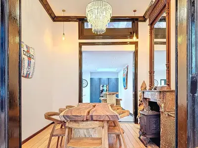 a dining room with a table and a fireplace at JAMES AT20 - luxury downtown Antwerp villa in Antwerp