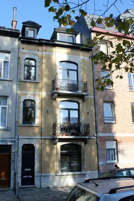 a large brick building with balconies on the side of it at B&B La Chambre du Zodiaque in Brussels