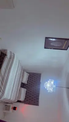 a room with a bed and a light on the wall at The Play Park Flat in Antwerp