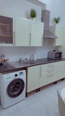a kitchen with a washing machine and a sink at The Play Park Flat in Antwerp