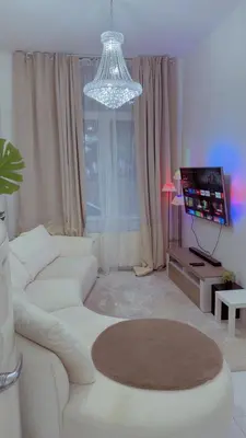 a living room with a white couch and a television at The Play Park Flat in Antwerp