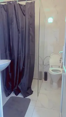 a bathroom with a toilet and a glass shower at The Play Park Flat in Antwerp